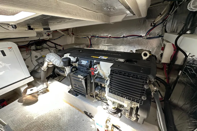 Slide: The Image of Engine room of 2013 Cruisers Yachts 45 Cantius, showcasing mechanical components and wiring. - 38