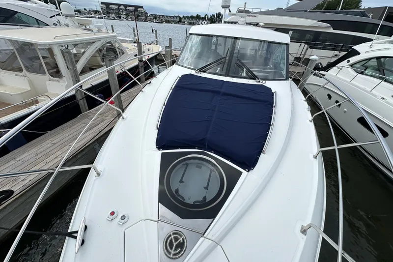 Slide: The Image of 2013 Cruisers Yachts 45 Cantius docked, featuring sleek design and spacious deck. - 42
