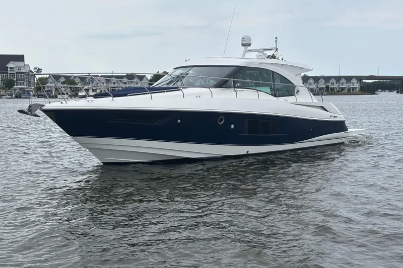 The Image of 2013 Cruisers Yachts 45 Cantius on calm water, showcasing sleek design and modern features. - 0