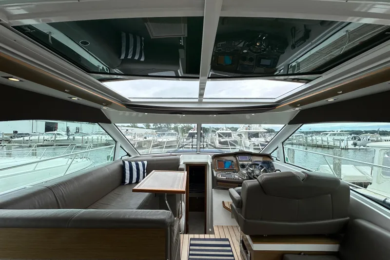 Slide: The Image of Interior of 2013 Cruisers Yachts 45 Cantius with helm, seating, and marina view. - 16
