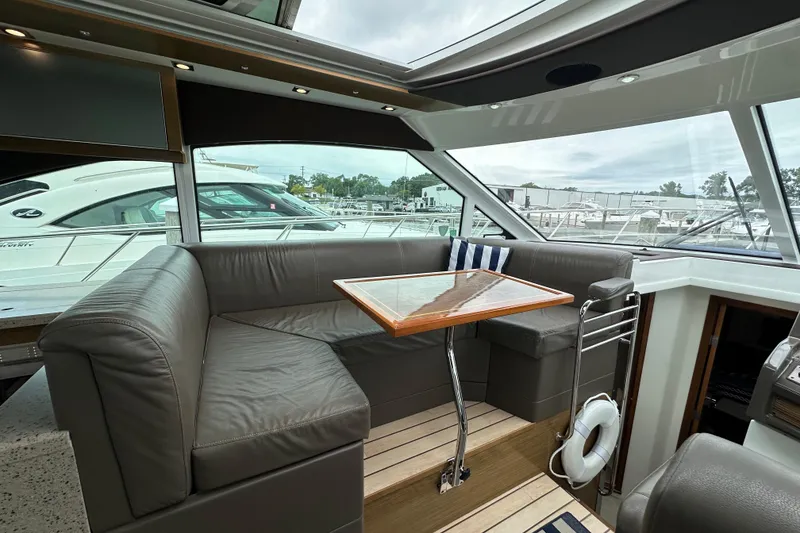 Slide: The Image of Luxurious 2013 Cruisers Yachts 45 Cantius interior with leather seating and wooden table. - 17