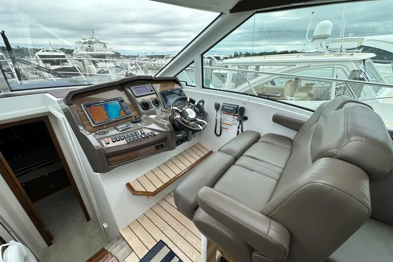 Slide: The Image of 2013 Cruisers Yachts 45 Cantius helm with modern navigation equipment and comfortable seating. - 18