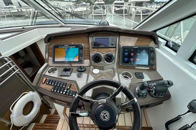 Slide: The Image of Helm of 2013 Cruisers Yachts 45 Cantius with navigation screens and controls. - 19