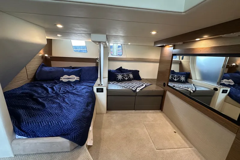 Slide: The Image of Luxurious 2013 Cruisers Yachts 45 Cantius cabin with blue bedding and elegant decor. - 35