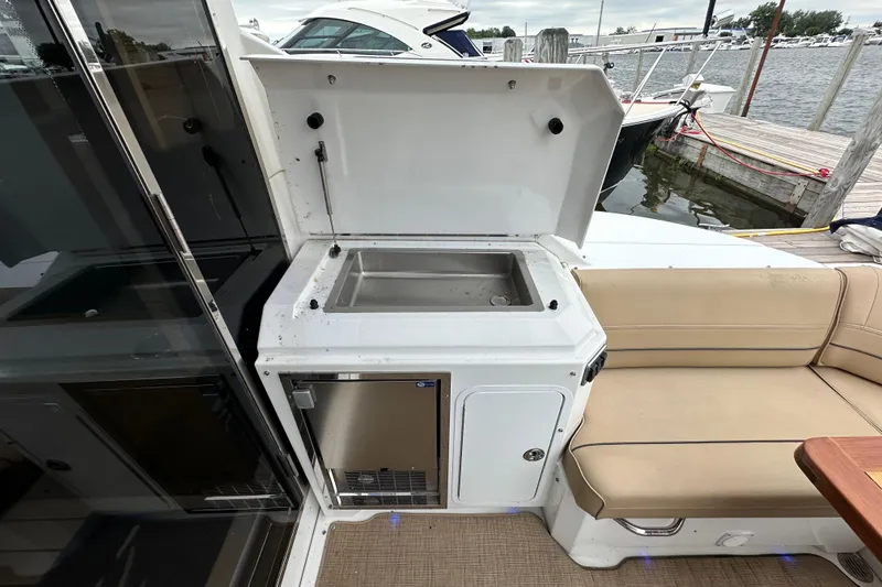 Slide: The Image of Outdoor kitchenette on 2013 Cruisers Yachts 45 Cantius, featuring sink and seating area. - 6