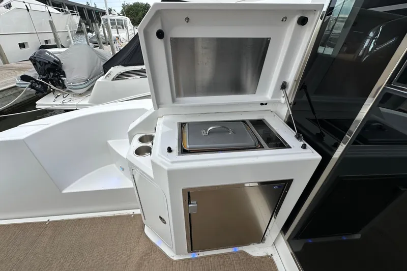 Slide: The Image of Outdoor kitchen on 2013 Cruisers Yachts 45 Cantius, featuring grill and storage. - 7