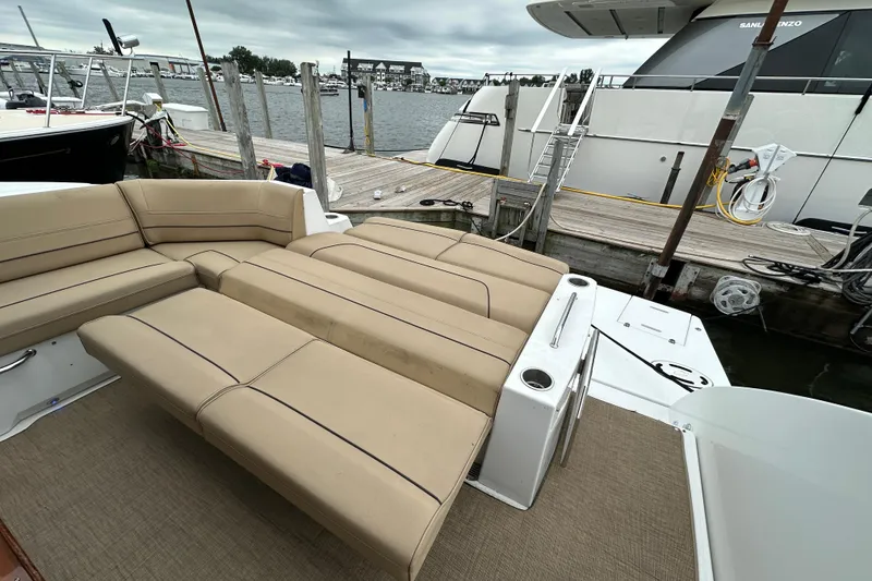 Slide: The Image of Luxurious 2013 Cruisers Yachts 45 Cantius with spacious tan seating at marina dock. - 8