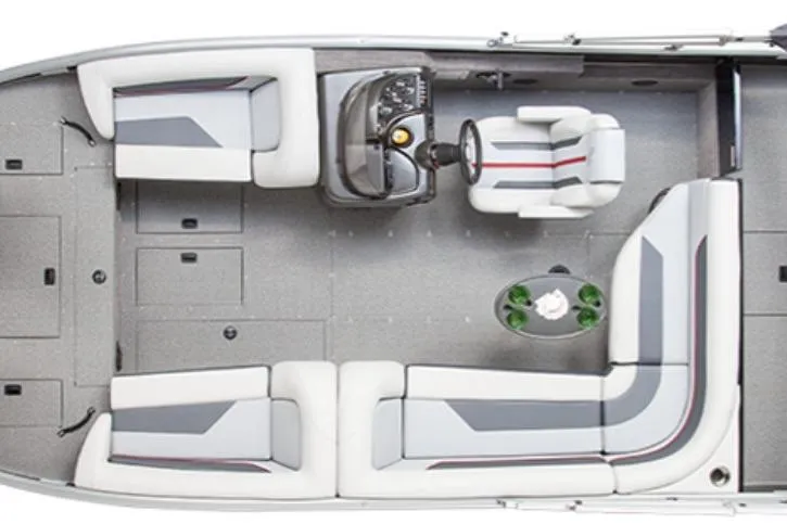 Slide: The Image of 2026 Lowe Sport Deck 224 boat with canopy on trailer, parked by a metal building. - 1