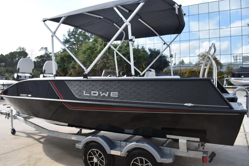 Slide: The Image of 2026 Lowe Sport Deck 224 boat with canopy on trailer, modern design. - 10