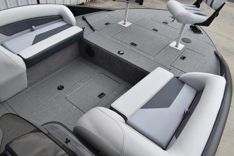Slide: The Image of 2026 Lowe Sport Deck 224 boat interior with gray seating and storage compartments. - 14