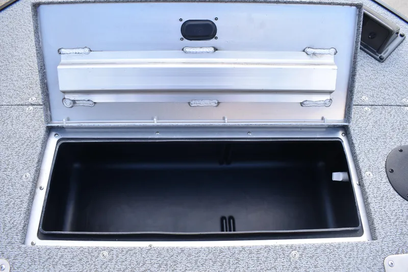 Slide: The Image of Open storage compartment on 2026 Lowe Sport Deck 224 boat, featuring durable construction. - 17