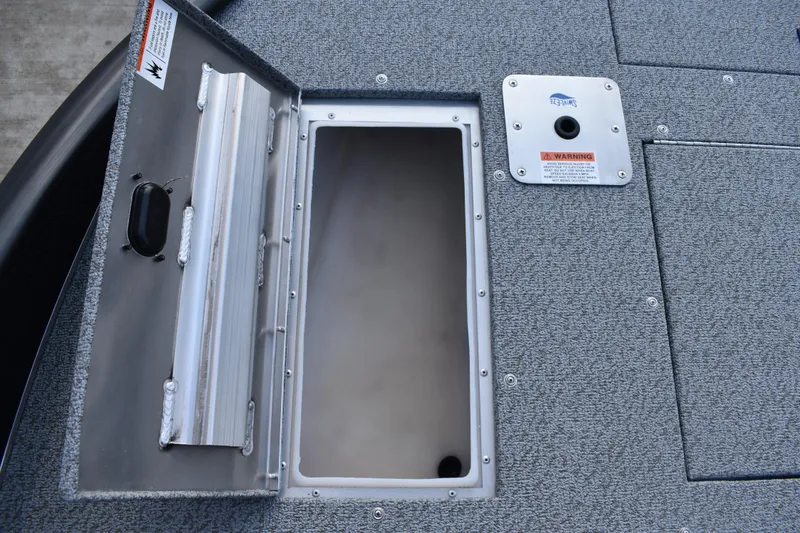 Slide: The Image of Open storage compartment on 2026 Lowe Sport Deck 224 boat. - 19