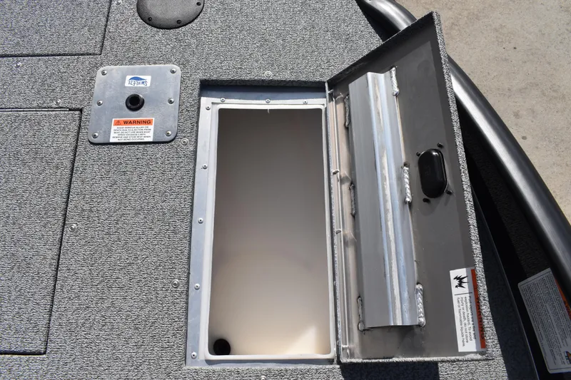 Slide: The Image of Open storage compartment on 2026 Lowe Sport Deck 224 boat, featuring textured flooring. - 21