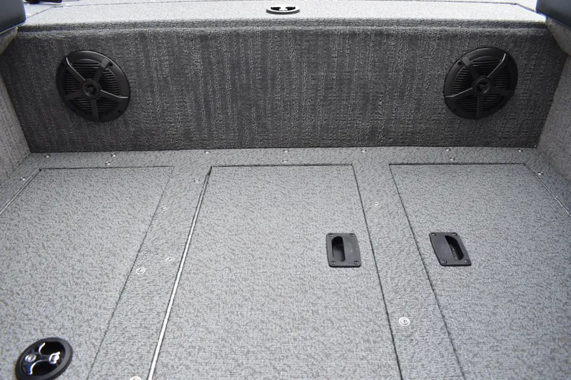 Slide: The Image of 2026 Lowe Sport Deck 224 boat interior with carpeted flooring and built-in speakers. - 24