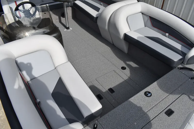Slide: The Image of 2026 Lowe Sport Deck 224 interior with gray seating and steering console. - 28