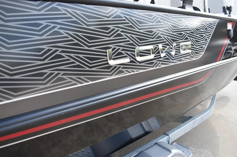 Slide: The Image of 2026 Lowe Sport Deck 224 boat with geometric design and red accents. - 3