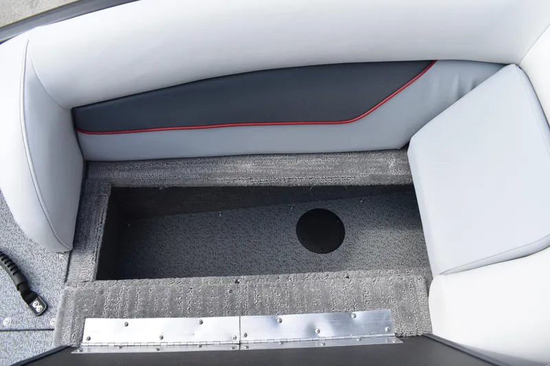 Slide: The Image of 2026 Lowe Sport Deck 224 boat interior storage compartment with gray upholstery and red trim. - 30