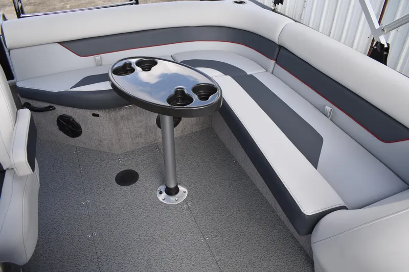 Slide: The Image of 2026 Lowe Sport Deck 224 interior with gray seating and a central table. - 34