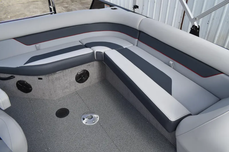 Slide: The Image of 2026 Lowe Sport Deck 224 boat interior with gray seating and speakers. - 36