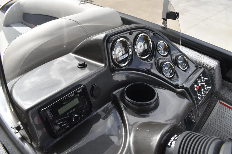 Slide: The Image of 2026 Lowe Sport Deck 224 dashboard with gauges, controls, and audio system. - 49