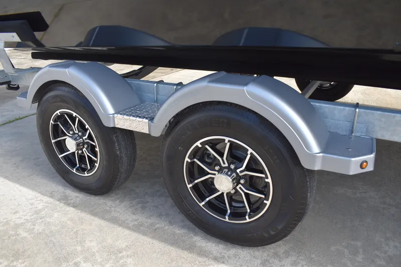 Slide: The Image of Trailer wheels of a 2026 Lowe Sport Deck 224 boat, featuring sleek black rims. - 5