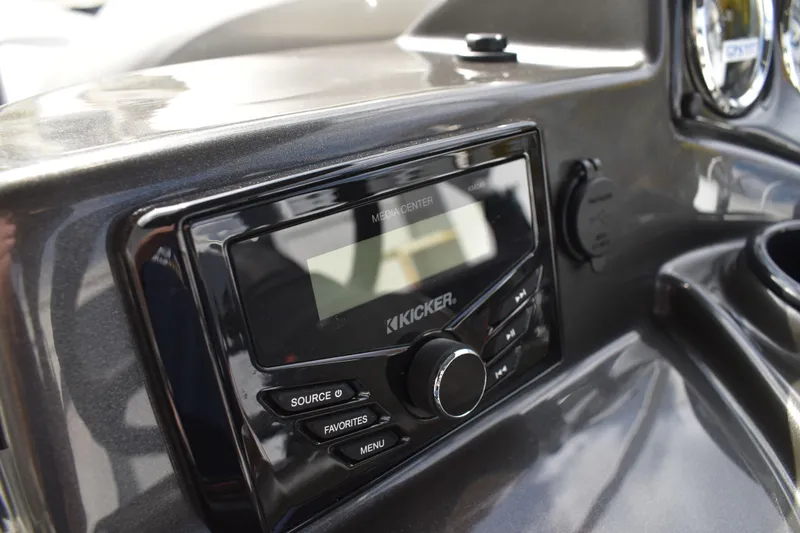 Slide: The Image of 2026 Lowe Sport Deck 224 dashboard with Kicker media center controls. - 50