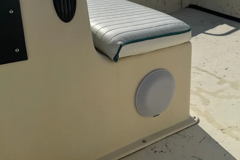 Slide: The Image of Carolina Skiff Semi-V 1980 boat interior with cushioned seat and speaker, 2000 model. - 11