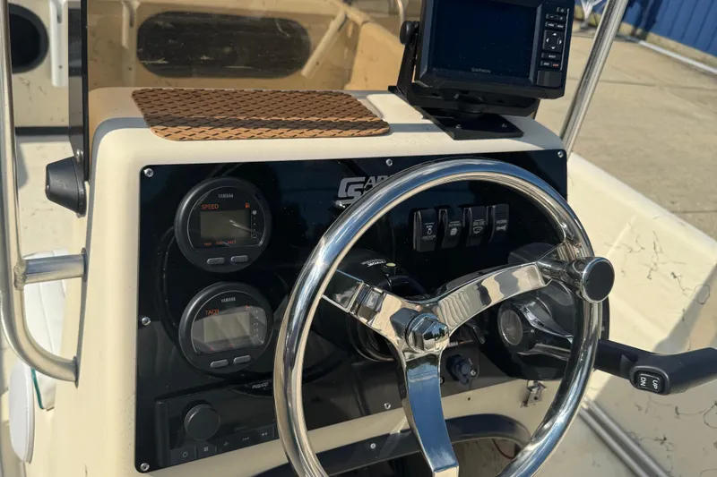 Slide: The Image of Steering console of a 2000 Carolina Skiff Semi-V 1980 with gauges and controls. - 6