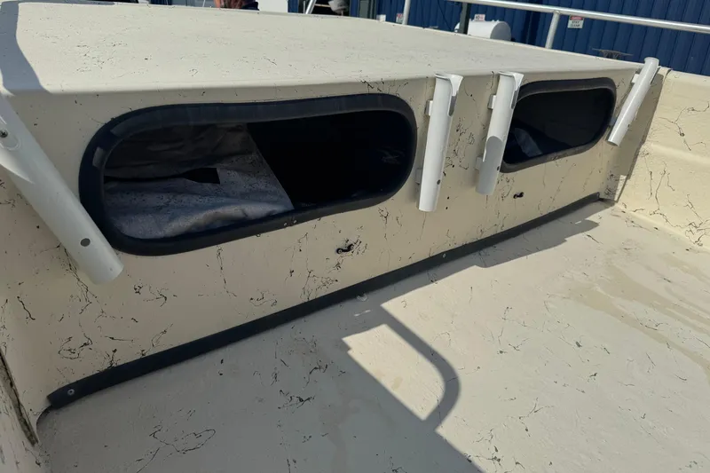 Slide: The Image of 2000 Carolina Skiff Semi-V 1980 boat interior with rod holders and storage compartments. - 7