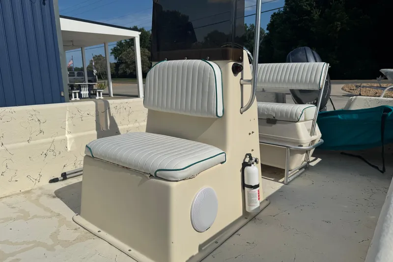 Slide: The Image of 2000 Carolina Skiff Semi-V 1980 boat interior with white cushioned seating and fire extinguisher. - 8