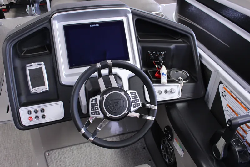 Slide: The Image of Cockpit of 2022 Premier Intrigue 230 Bed boat with steering wheel and control panel. - 11