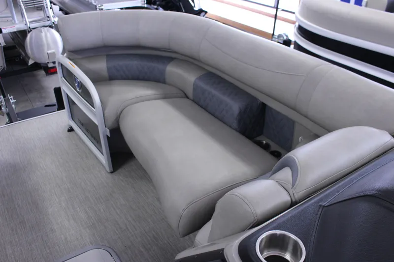 Slide: The Image of Luxurious seating on 2022 Premier Intrigue 230 Bed pontoon boat, featuring plush gray upholstery. - 13