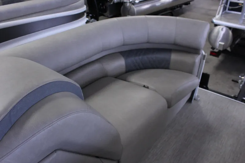 Slide: The Image of Luxurious seating on 2022 Premier Intrigue 230 Bed pontoon boat, featuring plush gray upholstery. - 14