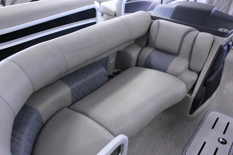 Slide: The Image of Luxurious seating on 2022 Premier Intrigue 230 Bed pontoon boat, featuring plush gray upholstery. - 15