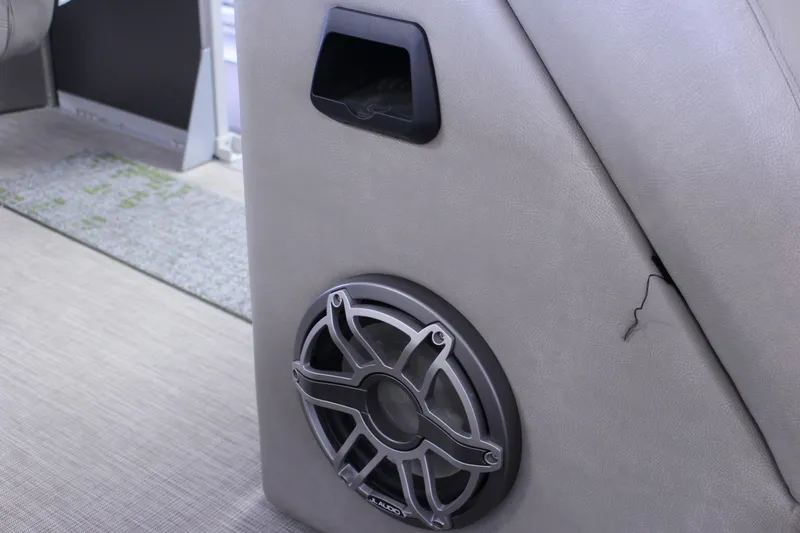 Slide: The Image of 2022 Premier Intrigue 230 Bed interior with speaker and storage compartment. - 17