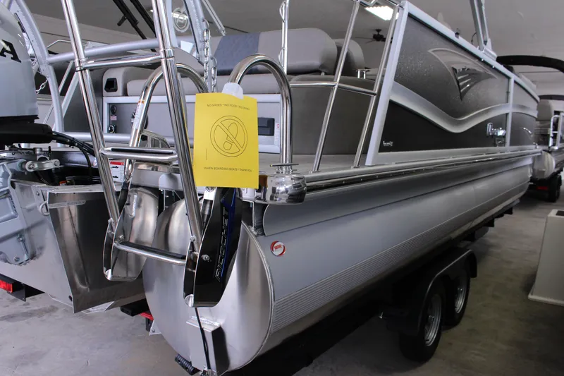 Slide: The Image of 2022 Premier Intrigue 230 Bed pontoon boat with ladder and caution sign. - 2