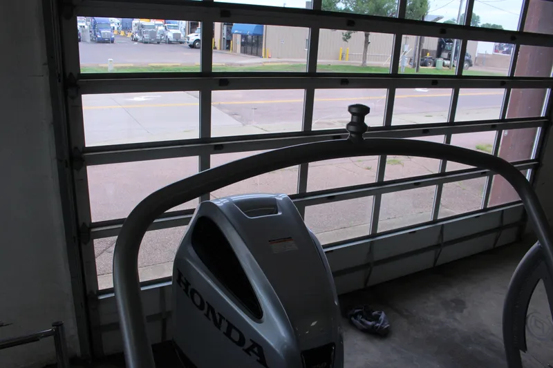 Slide: The Image of Garage interior with a Honda engine, featuring a Premier Intrigue 230 Bed, 2022 model. - 23