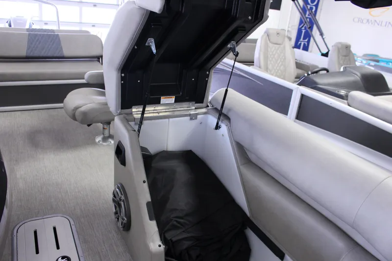 Slide: The Image of 2022 Premier Intrigue 230 Bed interior with open storage compartment and seating. - 25