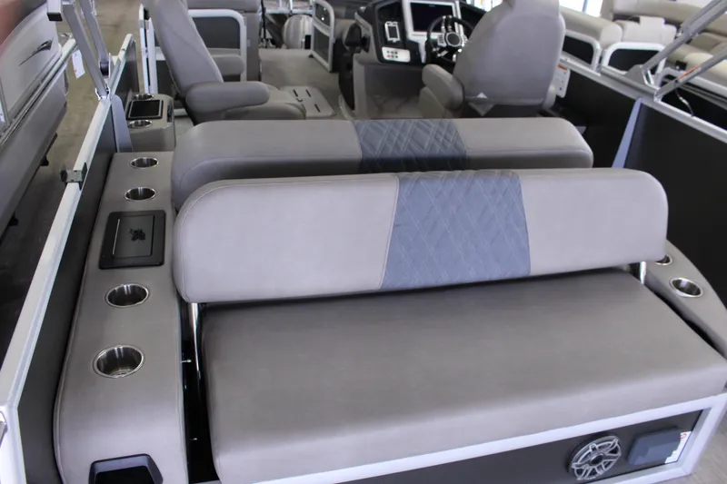 Slide: The Image of 2022 Premier Intrigue 230 Bed interior with gray seating and cup holders. - 5