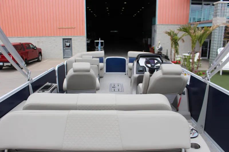 Slide: The Image of 2022 Premier Sunsation 230 pontoon boat interior with plush seating and modern helm. - 14