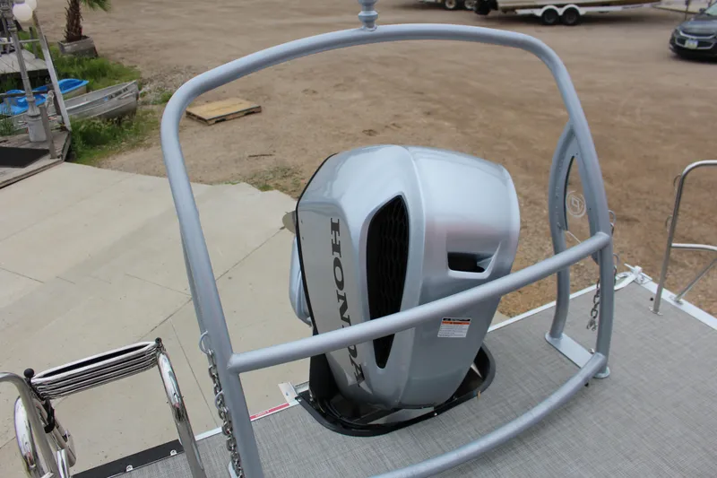 Slide: The Image of 2022 Premier Sunsation 230 boat with Honda outboard motor, docked on a concrete ramp. - 15