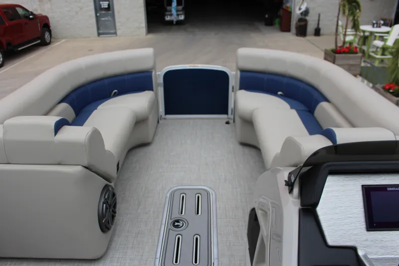 Slide: The Image of 2022 Premier Sunsation 230 boat interior with plush seating and modern dashboard. - 3