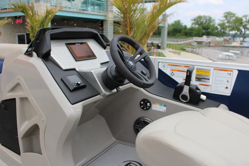 Slide: The Image of 2022 Premier Sunsation 230 boat dashboard with steering wheel and control panel. - 5