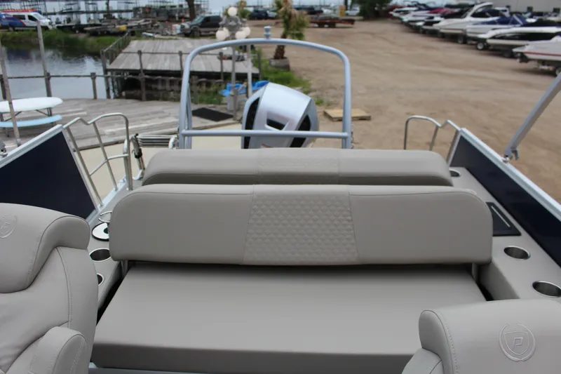 Slide: The Image of 2022 Premier Sunsation 230 boat interior with beige seating and cup holders. - 7