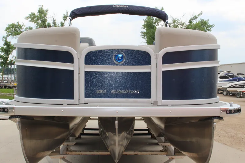 Slide: The Image of 2022 Premier Sunsation 230 pontoon boat, blue and white, docked outdoors. - 8