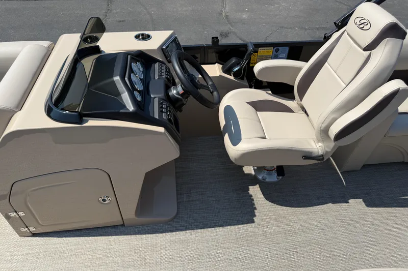 Slide: The Image of 2026 Bentley Pontoons Legacy 200 Navigator helm with beige captain's chair and dashboard. - 13