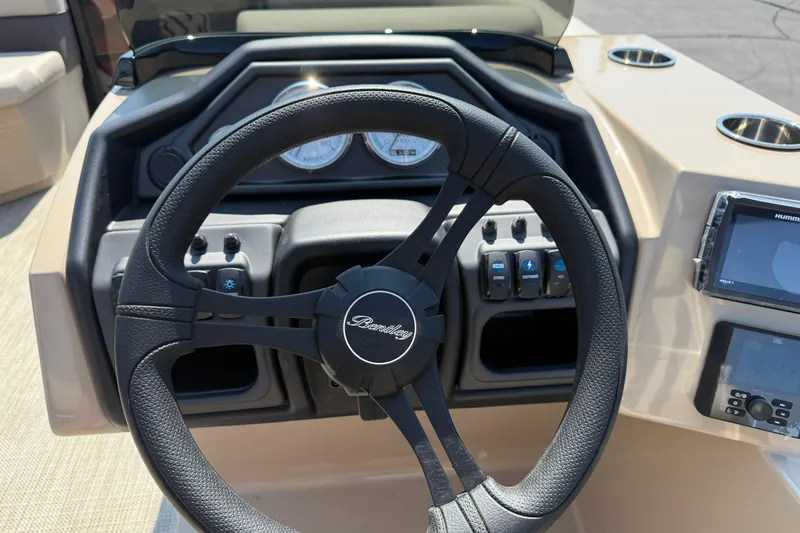 Slide: The Image of 2026 Bentley Pontoons Legacy 200 Navigator steering wheel and dashboard controls. - 15