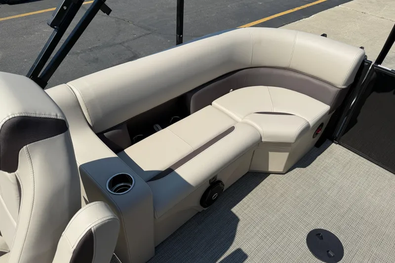 Slide: The Image of 2026 Bentley Pontoons Legacy 200 Navigator interior seating with beige upholstery and cup holder. - 18
