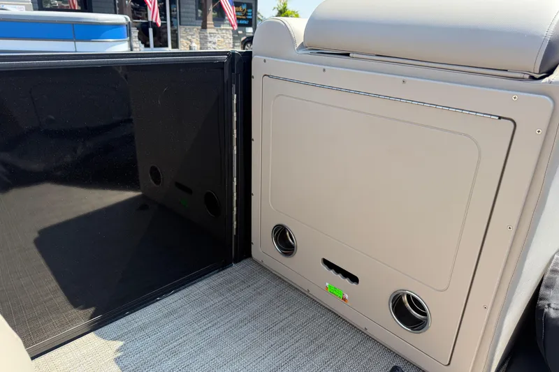 Slide: The Image of 2026 Bentley Pontoons Legacy 200 Navigator interior detail with storage compartment and cup holders. - 22