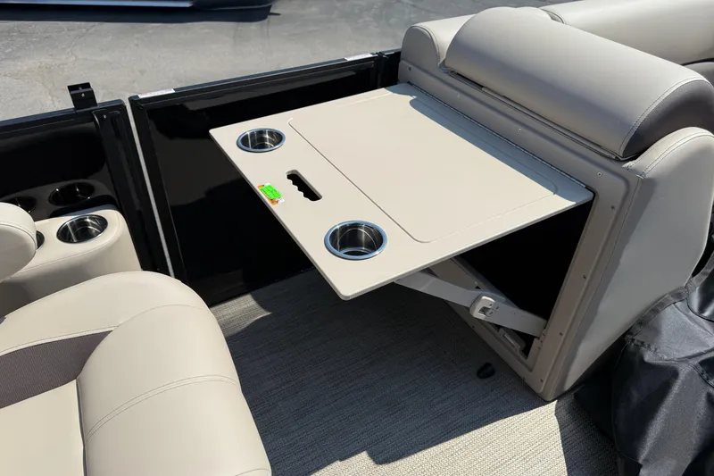 Slide: The Image of 2026 Bentley Pontoons Legacy 200 Navigator interior with foldable table and cup holders. - 23